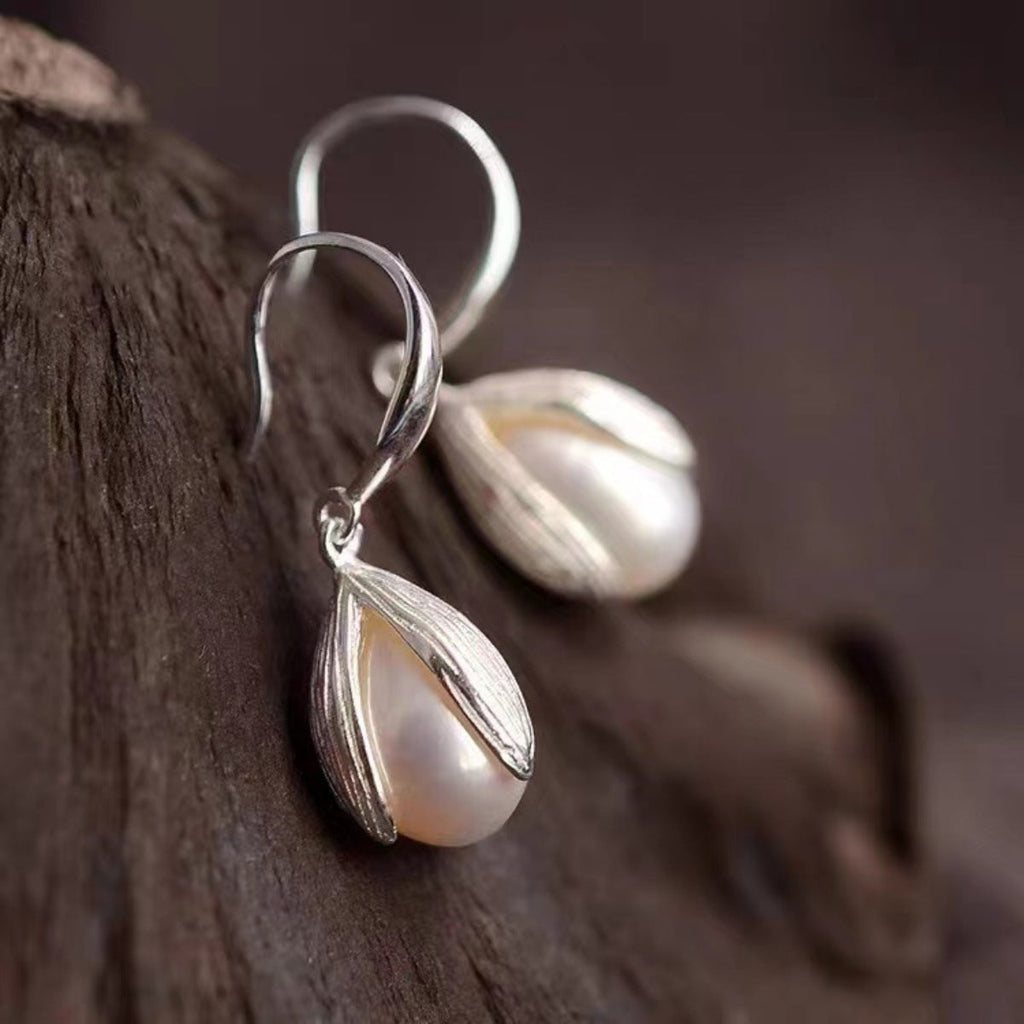 Sterling silver drop earrings with elegant teardrop design, crafted by Shopimist, featuring polished, shiny silver finish.