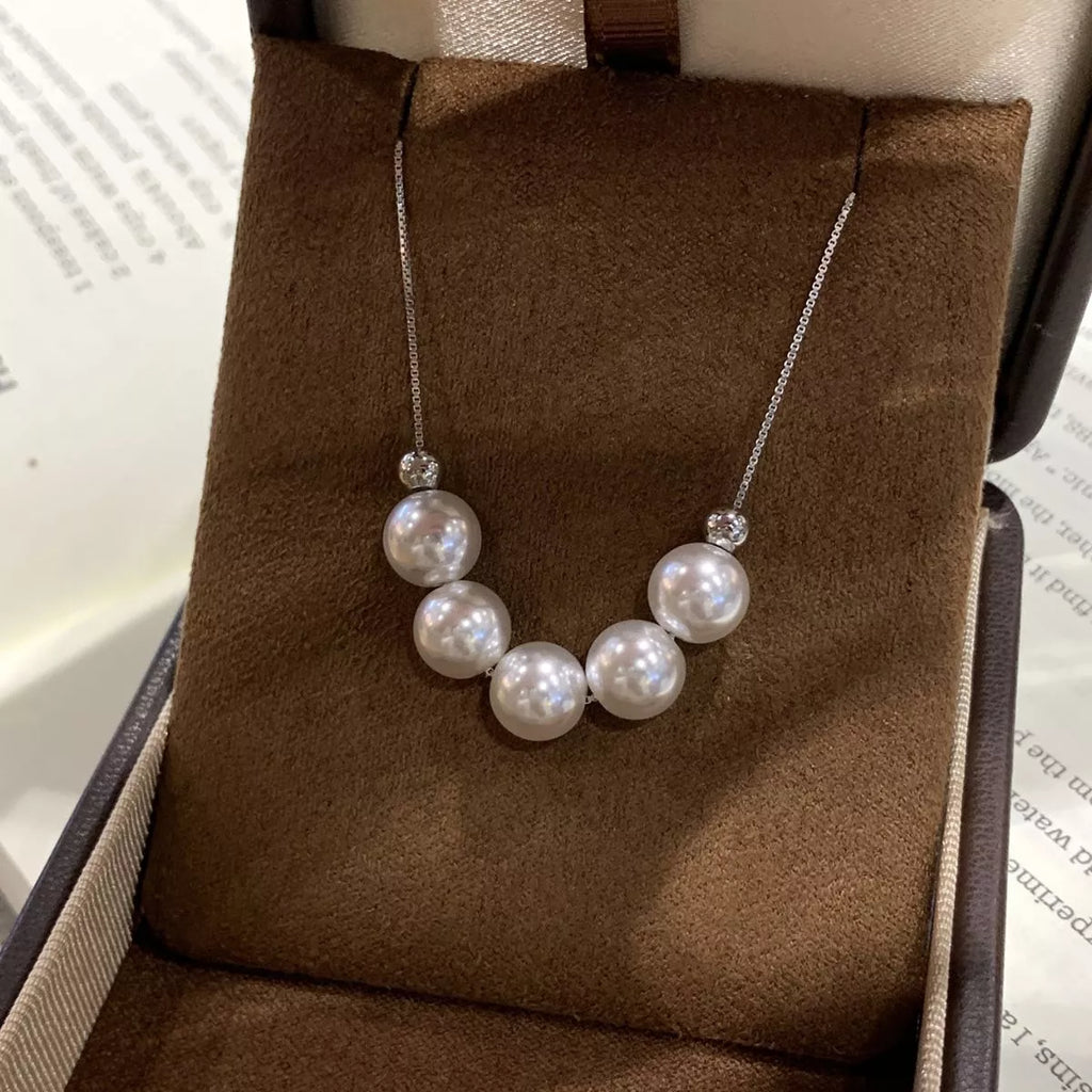 Adjustable pearl necklace by Shopimist featuring white pearls on a delicate chain with a secure clasp.