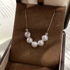 Adjustable pearl necklace by Shopimist featuring white pearls on a delicate chain with a secure clasp.