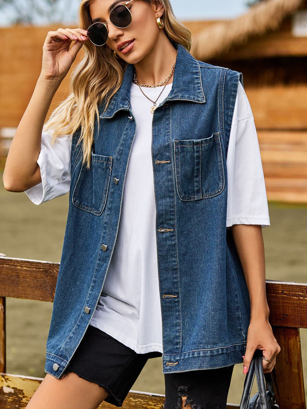 VYSN button down denim vest featuring classic blue denim fabric, collar, and front button closure, casual fashion clothing.