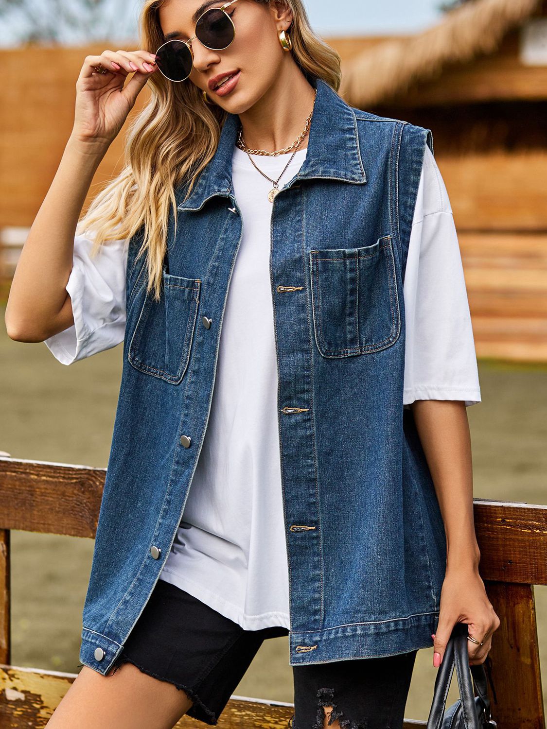 VYSN button down denim vest featuring classic blue denim fabric, collar, and front button closure, casual fashion clothing.