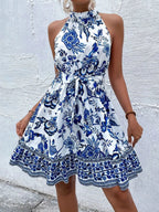 Printed sleeveless tie waist dress by Shopimist, featuring a stylish pattern and flattering silhouette, shown on a model.