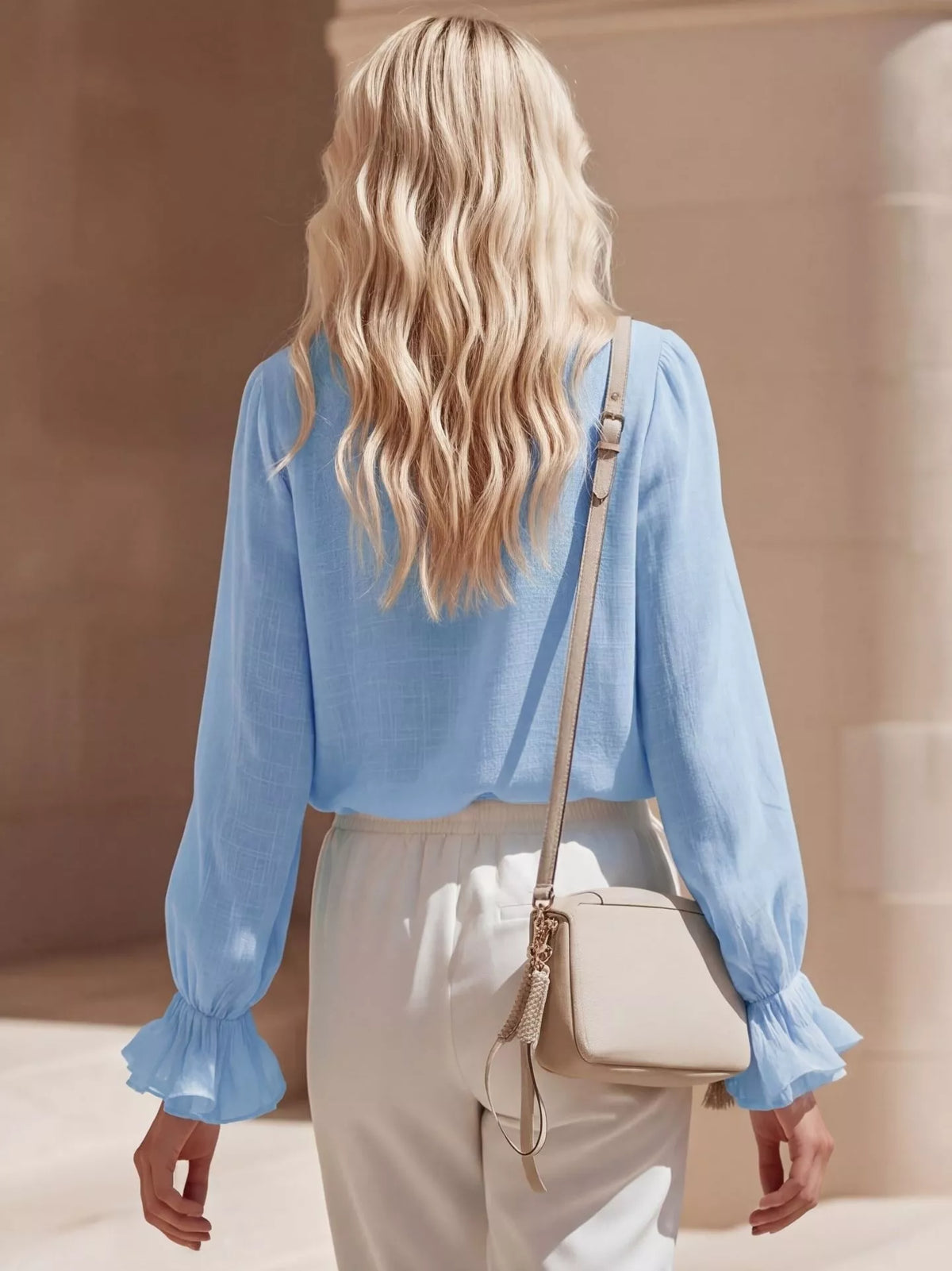 Ruffled V-neck long sleeve blouse by Plush Fashion Hub, featuring soft fabric and stylish ruffle details in a vibrant color.