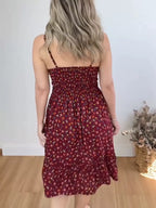 Floral print spaghetti strap midi dress with ruffle hem by Trendsi, featuring a flowy silhouette and vibrant floral pattern.
