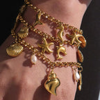 18K gold-plated sea shell charm bracelet with delicate chain and ocean-inspired shell charms, stylish jewelry accessory.