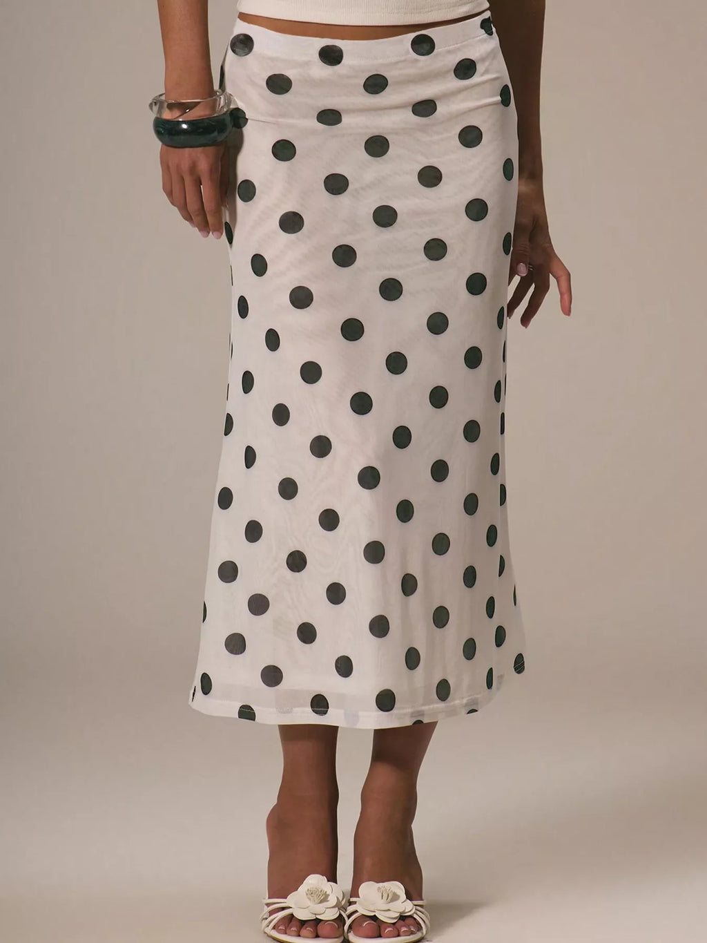 Women's polka dot midi skirt by Trendsi, vintage-inspired high-waisted A-line skirt with a classic pattern and flowing design.