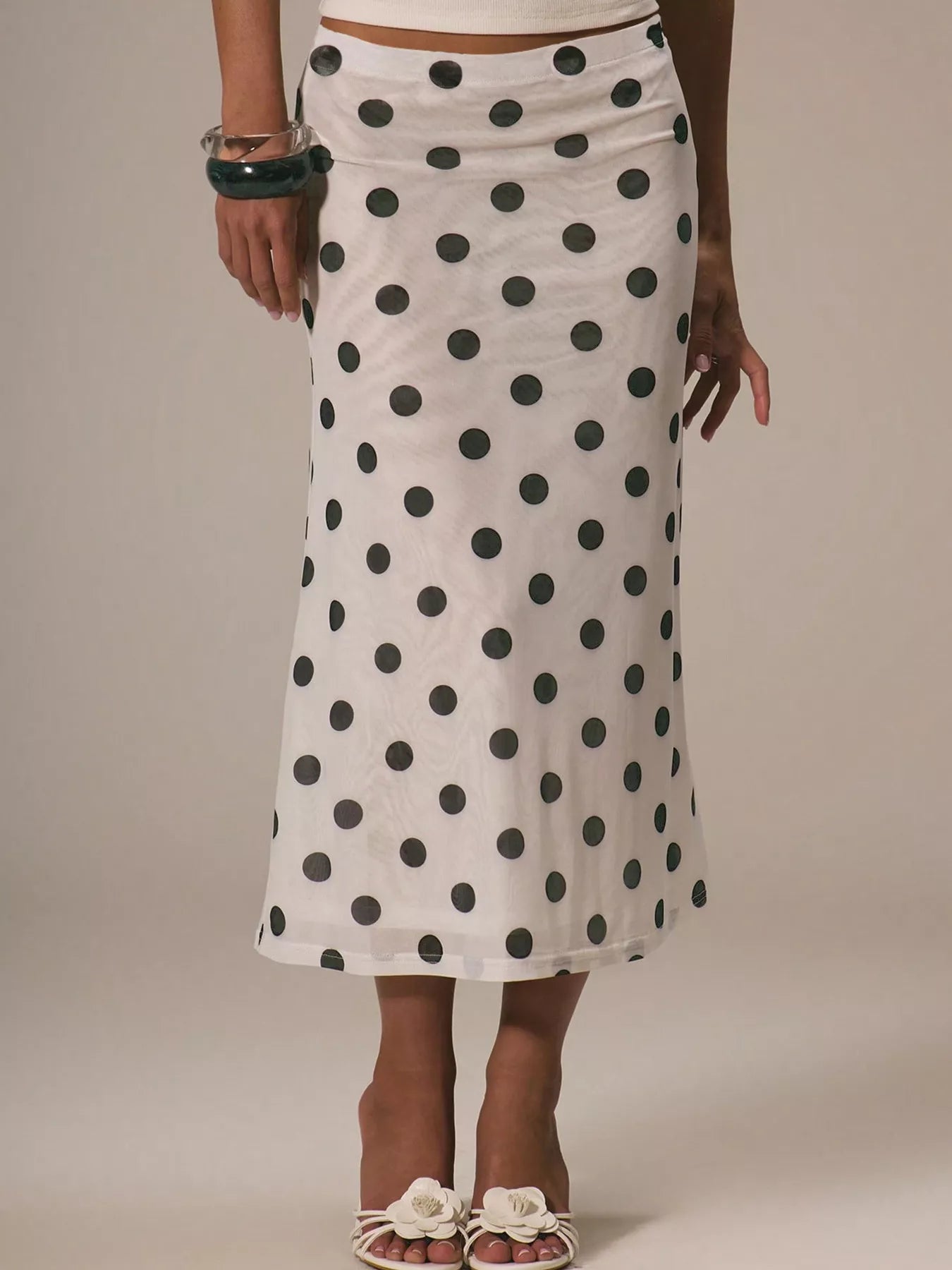 Women's polka dot midi skirt by Trendsi, vintage-inspired high-waisted A-line skirt with a classic pattern and flowing design.
