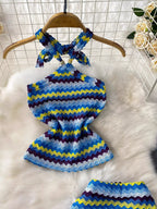 Women's striped knitted halter top and maxi skirt dress by Trendsi, featuring a stylish, comfortable knit design with bold stripes.