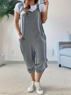 Casual loose fit spaghetti strap jumpsuit with pockets by Trendsi, featuring a relaxed style and lightweight fabric.