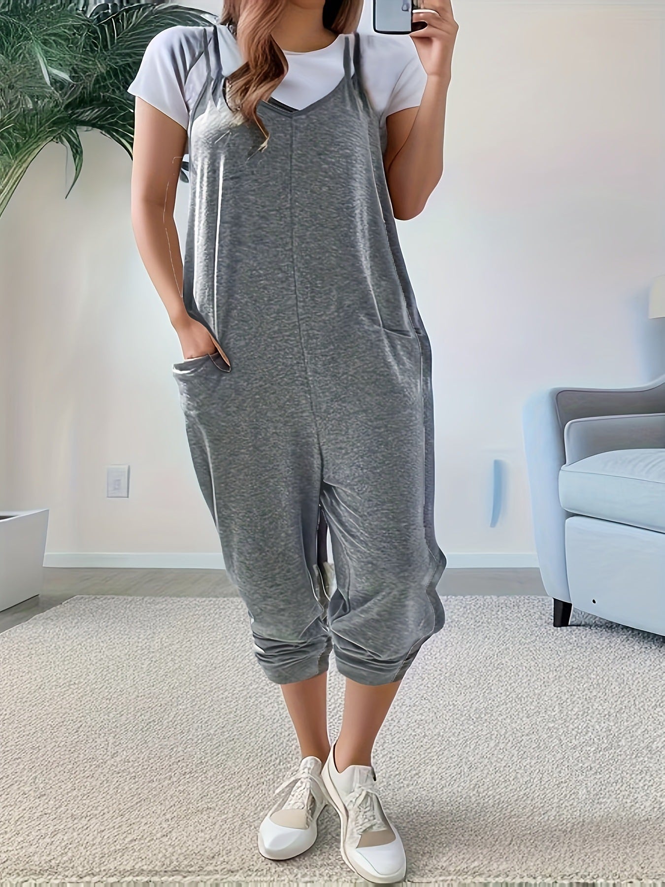 Casual loose fit spaghetti strap jumpsuit with pockets by Trendsi, featuring a relaxed style and lightweight fabric.