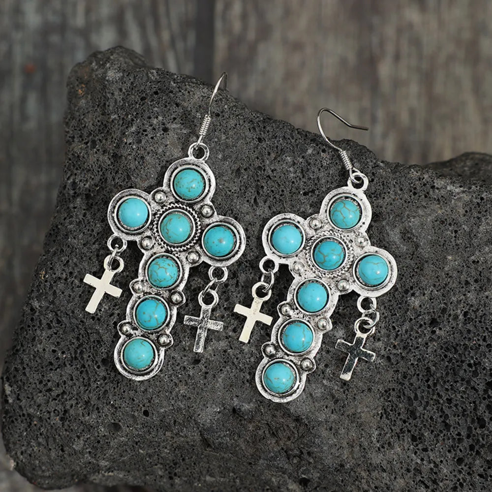 Artificial turquoise cross shape earrings by Shopimist featuring vibrant turquoise-colored cross design on silver-tone hooks