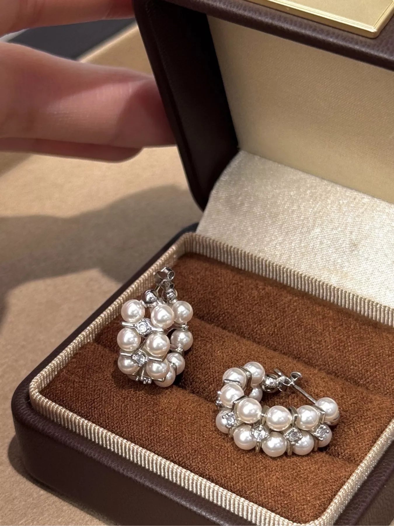Pearl hoop earrings from Plush Fashion Hub featuring elegant white pearls and gold-tone hoops for a stylish accessory.