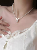 Pearl butterfly pendant necklace featuring a delicate pearl and butterfly charm on a silver chain, stylish jewelry by Shopimist.