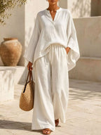 Plus size Trendsi loungewear set with a full size notched long sleeve top and wide-leg pants, laid out on a neutral background.