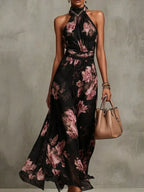 Plus size floral print sleeveless maxi dress from Trendsi, featuring a full-length design with vibrant floral patterns.