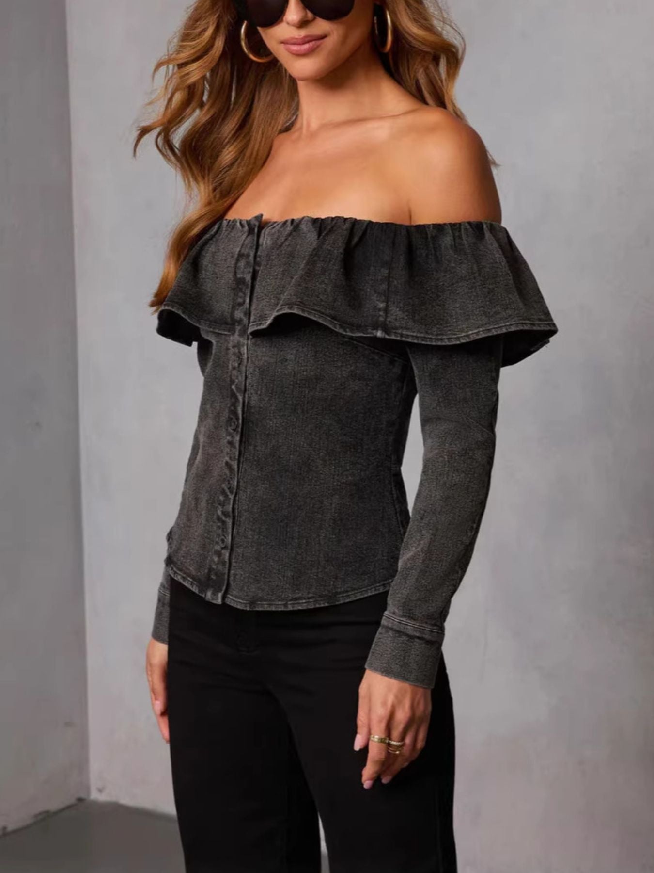 Women's off-shoulder ruffled denim blouse in soft blue from Trendsi, featuring casual style and feminine ruffle details.