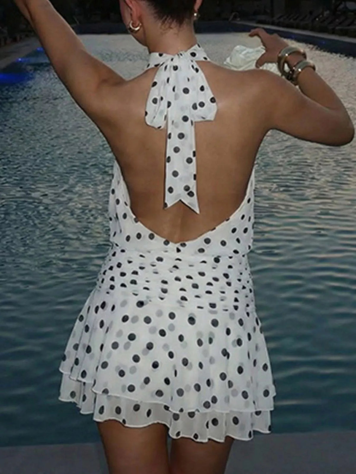 Polka dot halter neck ruffle dress by Plush Fashion Hub, featuring a stylish design with ruffles and a halter neckline.