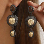 Vintage-inspired dangle earrings with gold accents, featuring intricate detailing and elegant design, perfect for stylish accessories.