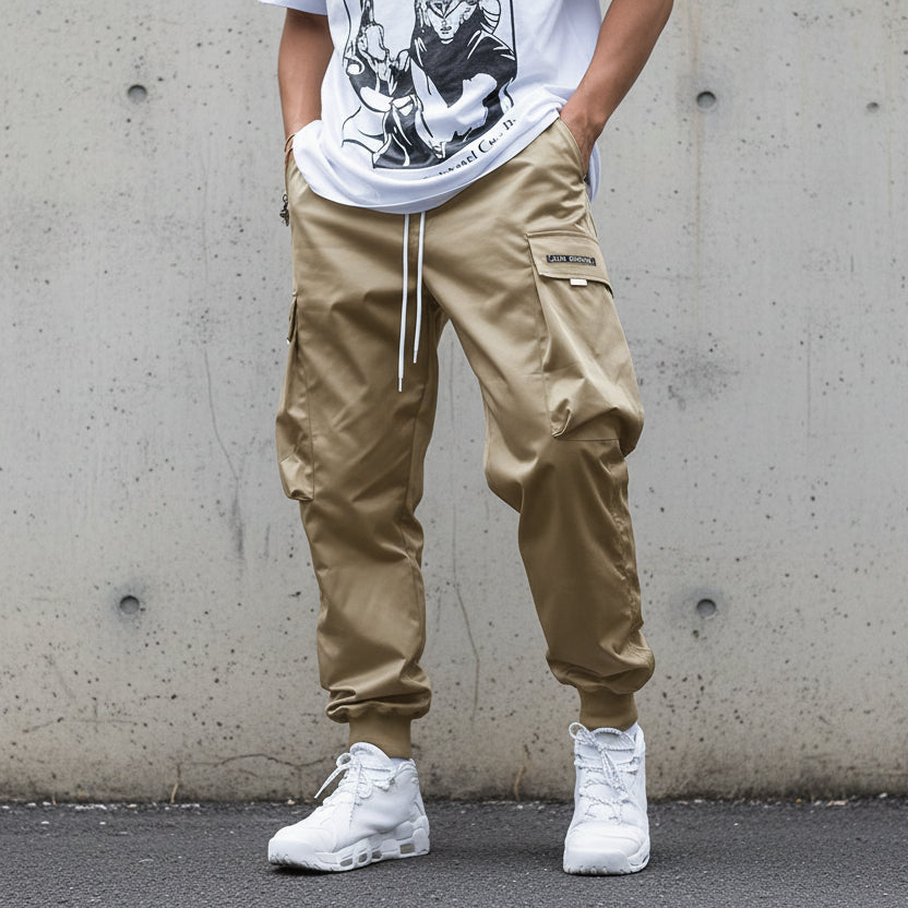 Men’s multi-pocket drawstring cargo pants in streetwear style by Plush Fashion Hub, featuring multiple pockets and a relaxed fit.