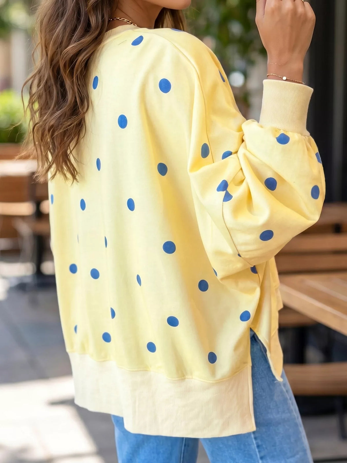 Oversized polka dot sweatshirt with side slit from Trendsi, featuring a relaxed fit and casual style in soft fabric.