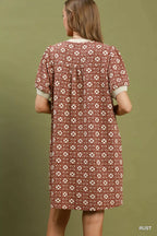 Umgee floral textured puff sleeve mini dress with a fitted bodice and lightweight fabric, styled for casual and summer wear.