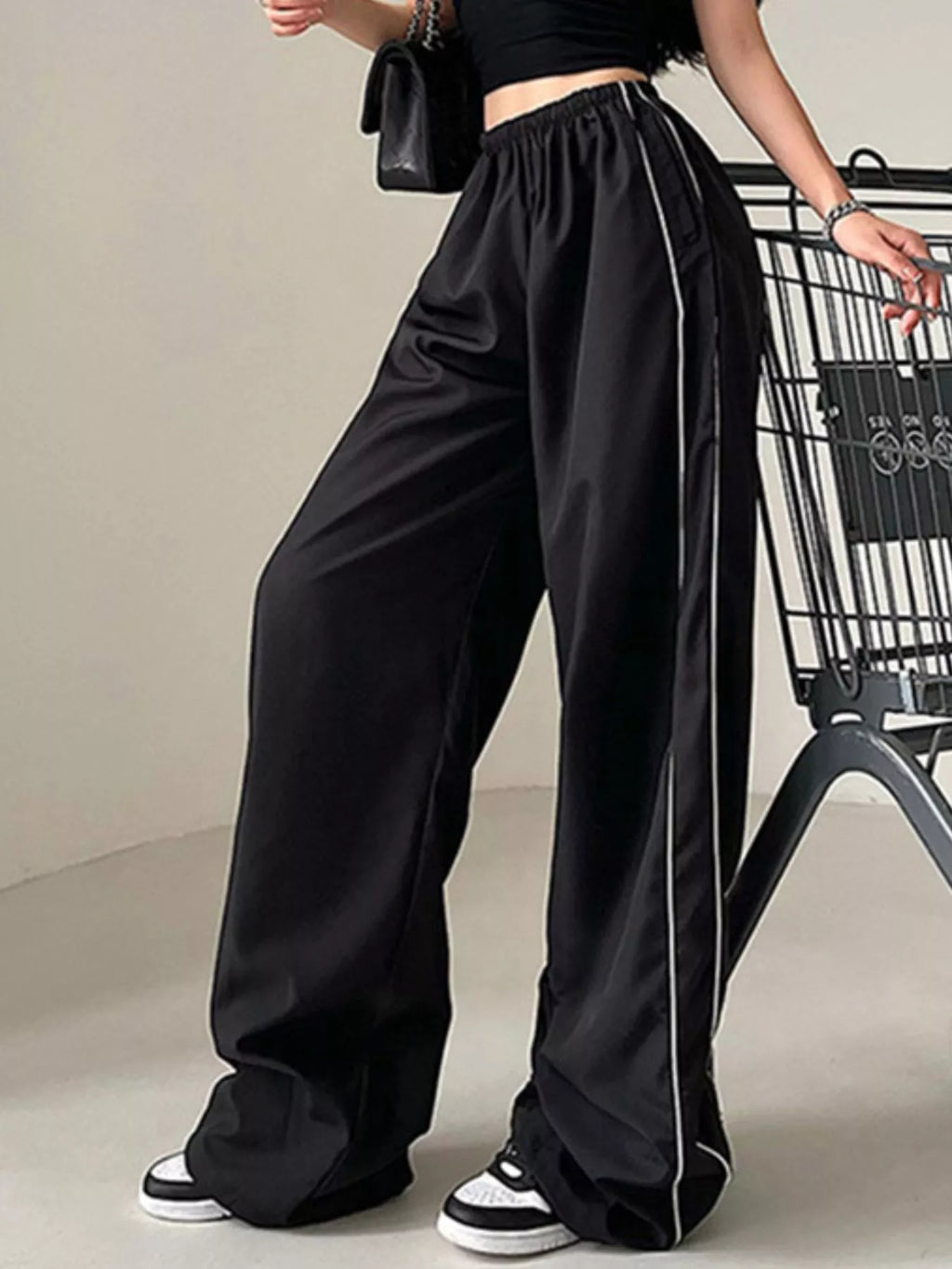 Lightweight women's high-rise wide-leg dress pants with elastic waist, stylish and comfortable for casual or office wear.