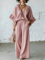 Women's loose-fit V-neck top and wide-leg pants two-piece casualwear set by Plush Fashion Hub, featuring comfortable, stylish fabric.