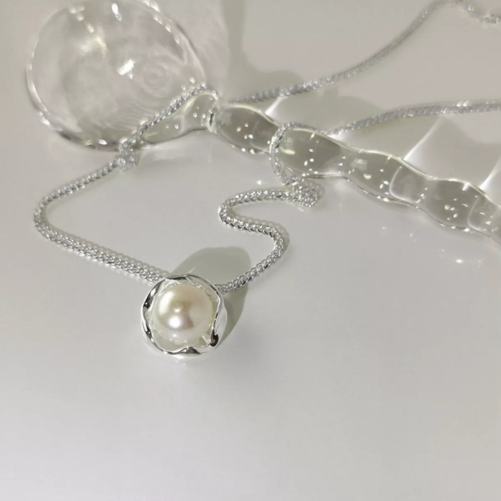 925 sterling silver pearl pendant necklace with a smooth, round pearl on a delicate silver chain, showcased against a neutral background.