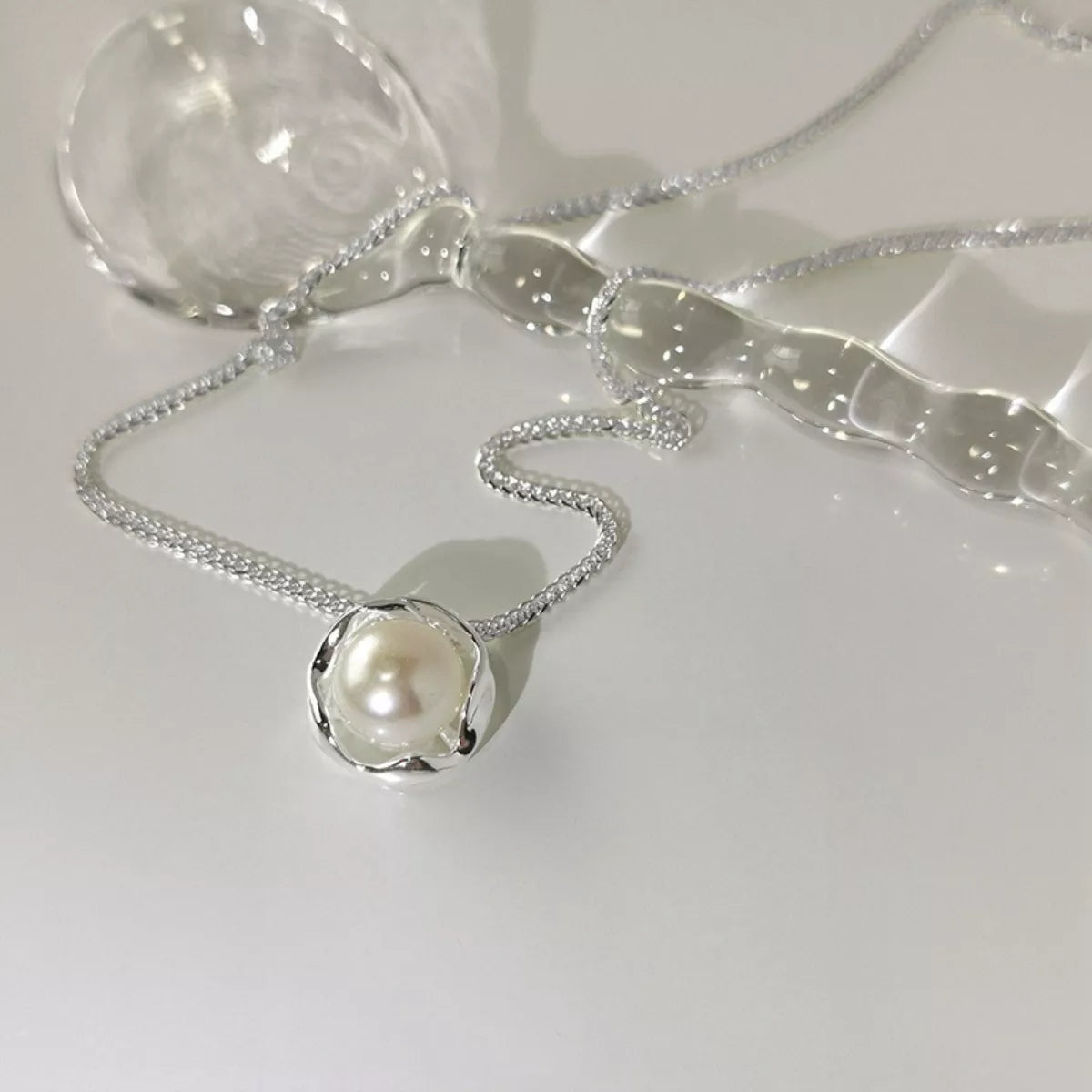 925 sterling silver pearl pendant necklace with a smooth, round pearl on a delicate silver chain, showcased against a neutral background.