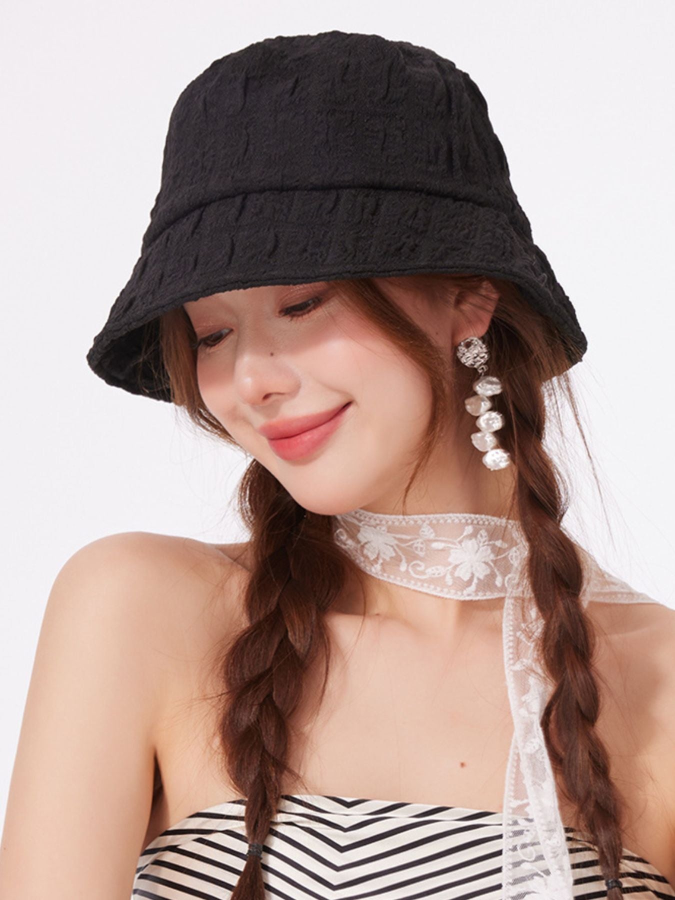 Women's lightweight textured summer bucket hat from Trendsi, breathable casual sun hat with a wide brim and relaxed fit.