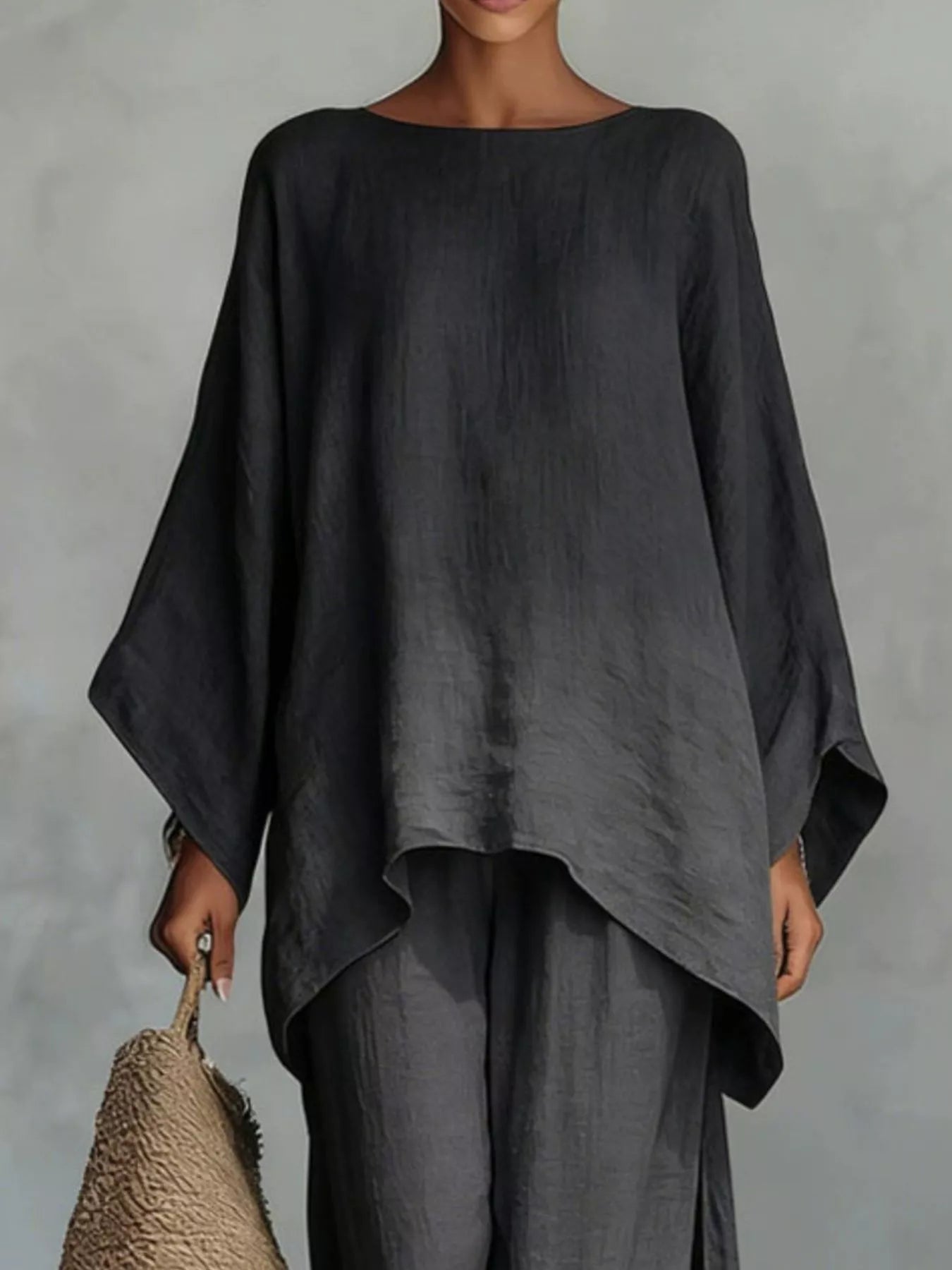 Plus size full size round neck top and wide leg pants set by Trendsi, featuring a comfortable, stylish matching pant set.