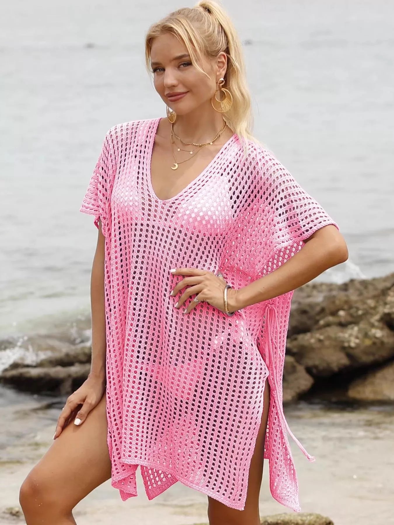 Openwork V-neck slit cover-up by Trendsi featuring lightweight fabric and stylish openwork design, perfect for beachwear or poolside.