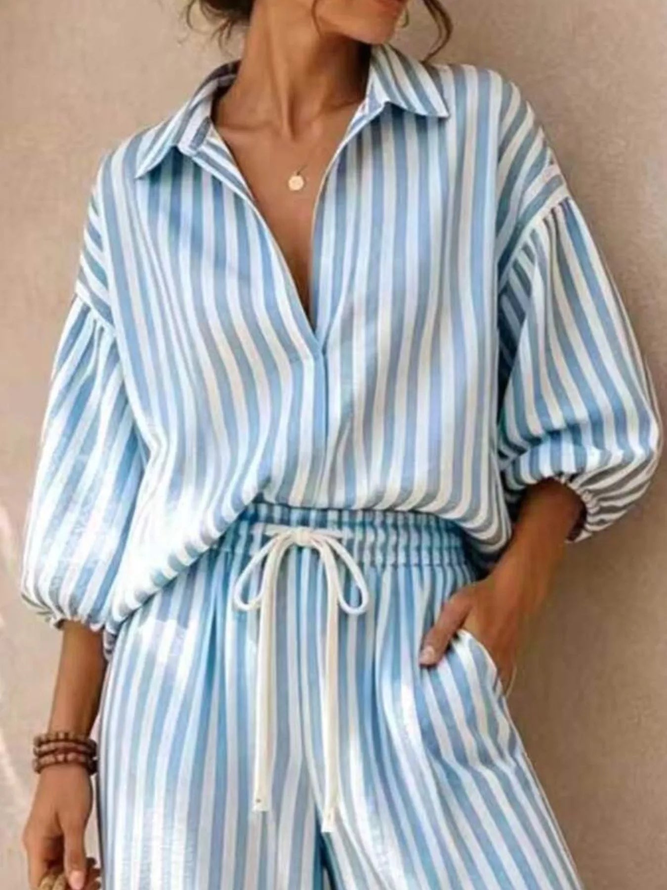 Plus size striped puff sleeve shirt and wide-leg drawstring pants set by Trendsi, featuring comfortable fabric and stylish design.