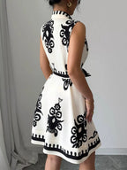 Sleeveless ruched printed tie waist dress by Shopimist with a flattering silhouette and vibrant floral pattern.