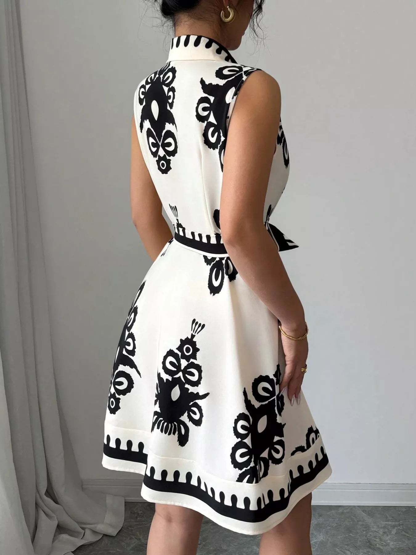 Sleeveless ruched printed tie waist dress by Shopimist with a flattering silhouette and vibrant floral pattern.
