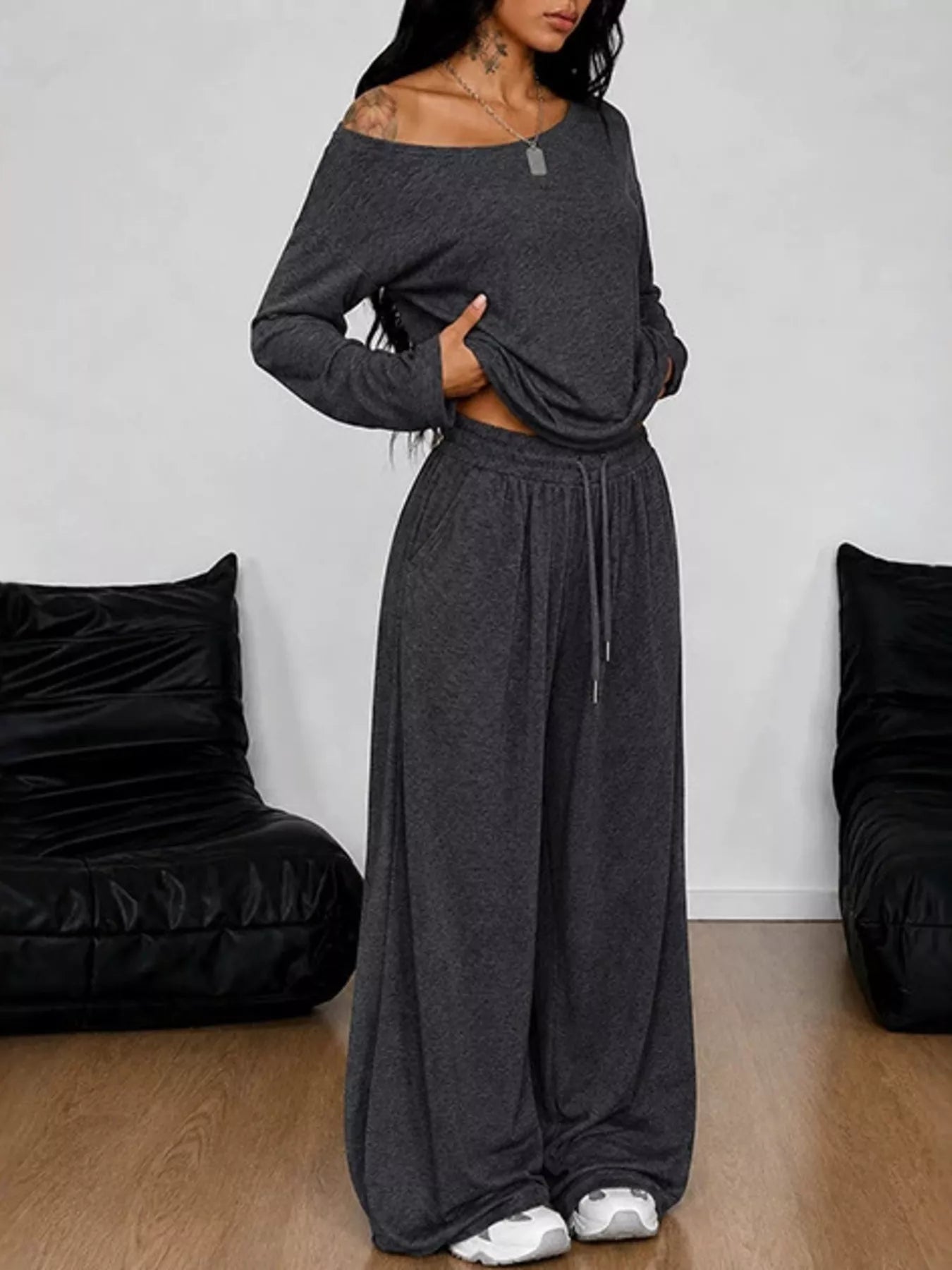 Plus size one-shoulder top and drawstring pants set by Trendsi, featuring a stylish, coordinated outfit with a relaxed fit.