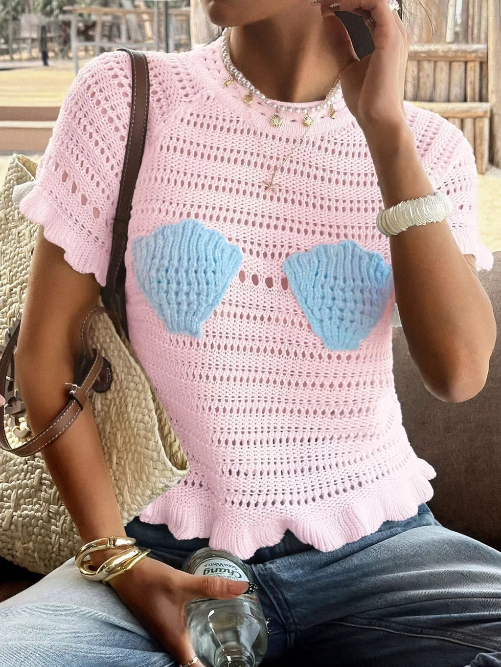 Openwork ruffled hem knit top from Trendsi featuring a stylish design with openwork detail and ruffled hem, perfect for casual wear.