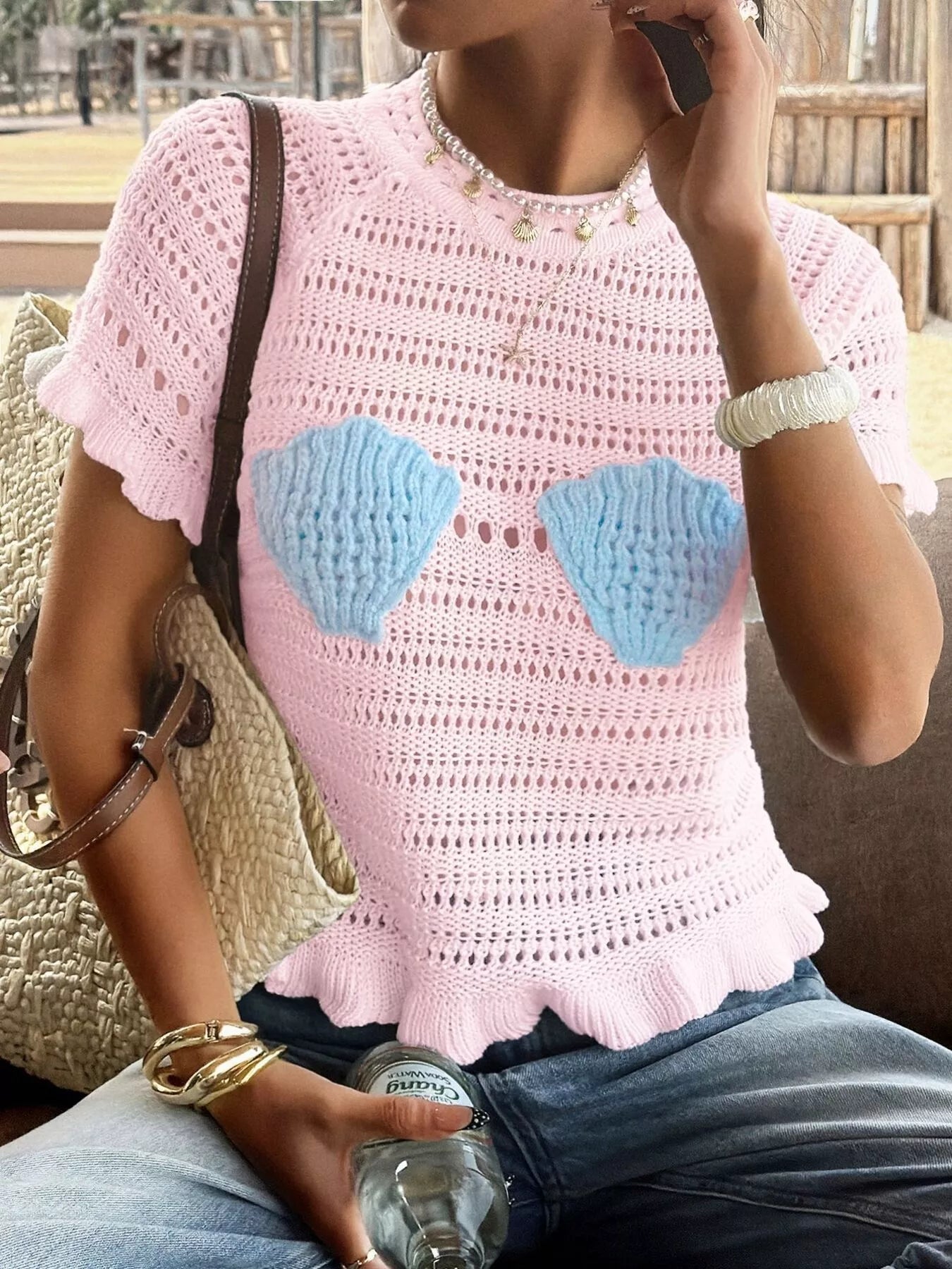Openwork ruffled hem knit top from Trendsi featuring a stylish design with openwork detail and ruffled hem, perfect for casual wear.