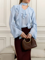 Elegant chiffon blouse with ruffle trim and tie neck detail, featuring a stylish, flowy design perfect for casual or dressy occasions.