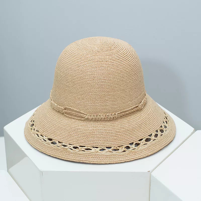 Woven straw bucket hat with decorative band from Plush Fashion Hub, featuring a wide brim and stylish design.