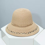 Woven straw bucket hat with decorative band from Plush Fashion Hub, featuring a wide brim and stylish design.