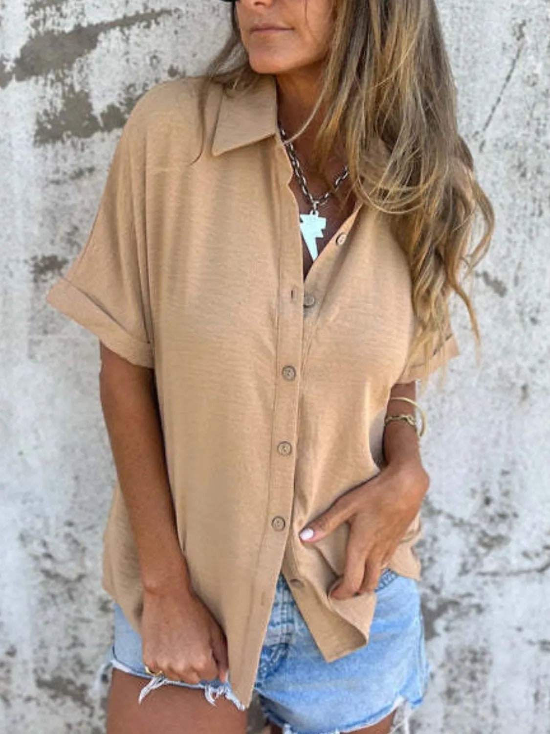 Women's collared half sleeve button-down blouse by Trendsi, showcasing a sophisticated office top with a tailored fit and classic design.