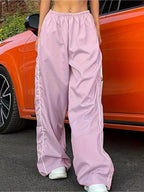 Lightweight women's high-rise wide-leg trousers with elastic waist, stylish dress pants by Trendsi, shown in a natural pose.