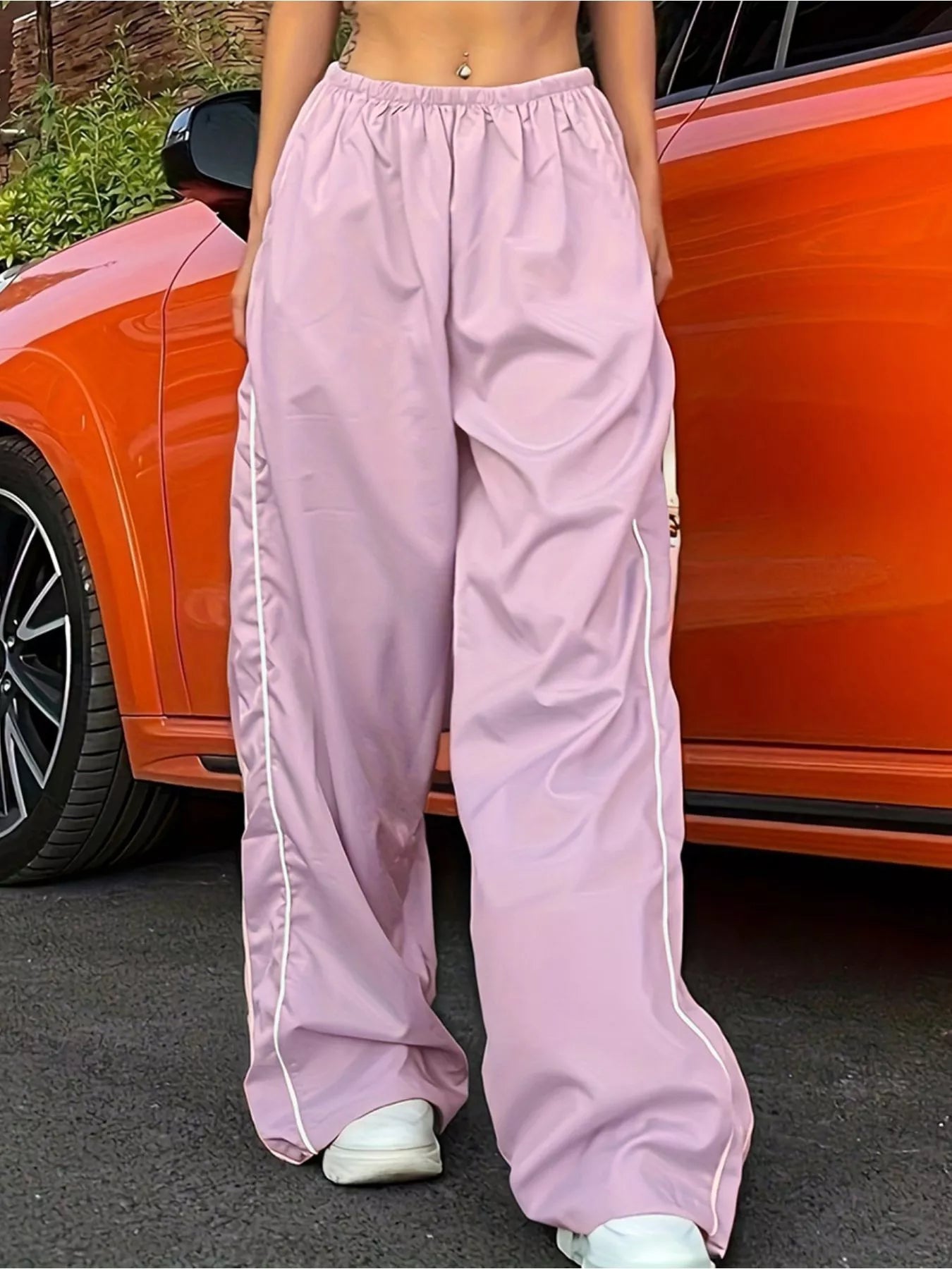 Lightweight women's high-rise wide-leg trousers with elastic waist, stylish dress pants by Trendsi, shown in a natural pose.