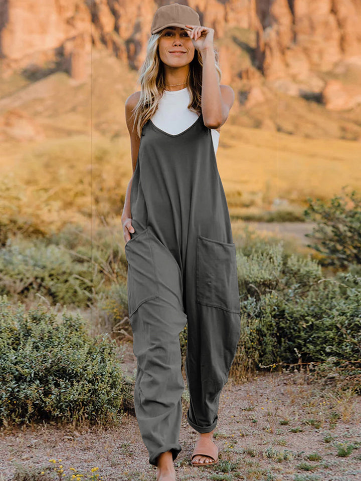 Women's sleeveless V-neck wide-leg jumpsuit with pockets, stylish women's apparel by Trendsi, shown in a relaxed fit with flowy legs.