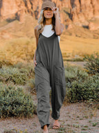 Women's sleeveless V-neck wide-leg jumpsuit with pockets, stylish women's apparel by Trendsi, shown in a relaxed fit with flowy legs.
