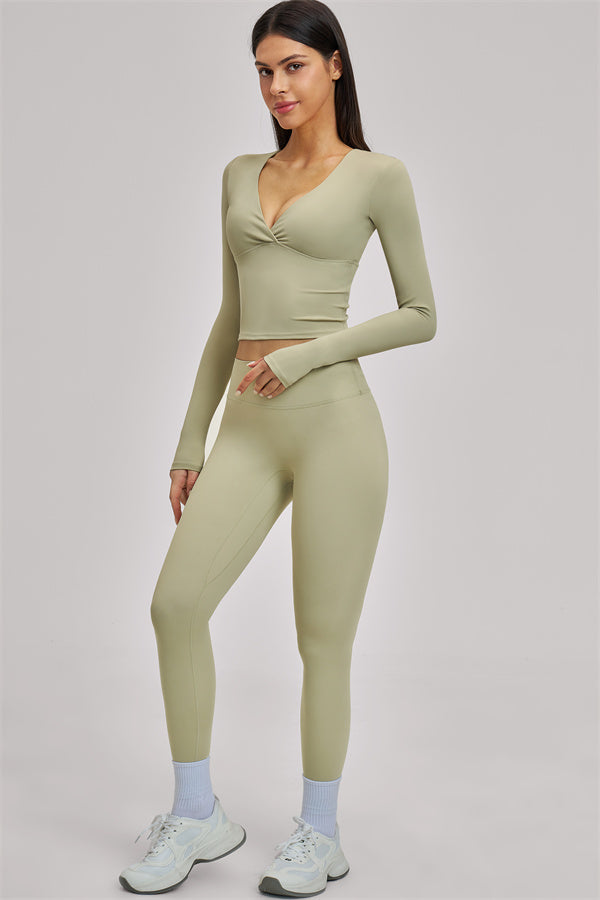 Fitglutes Activewear long sleeve crop top from The Swoon collection, showing a fitted black workout top with a high neckline.