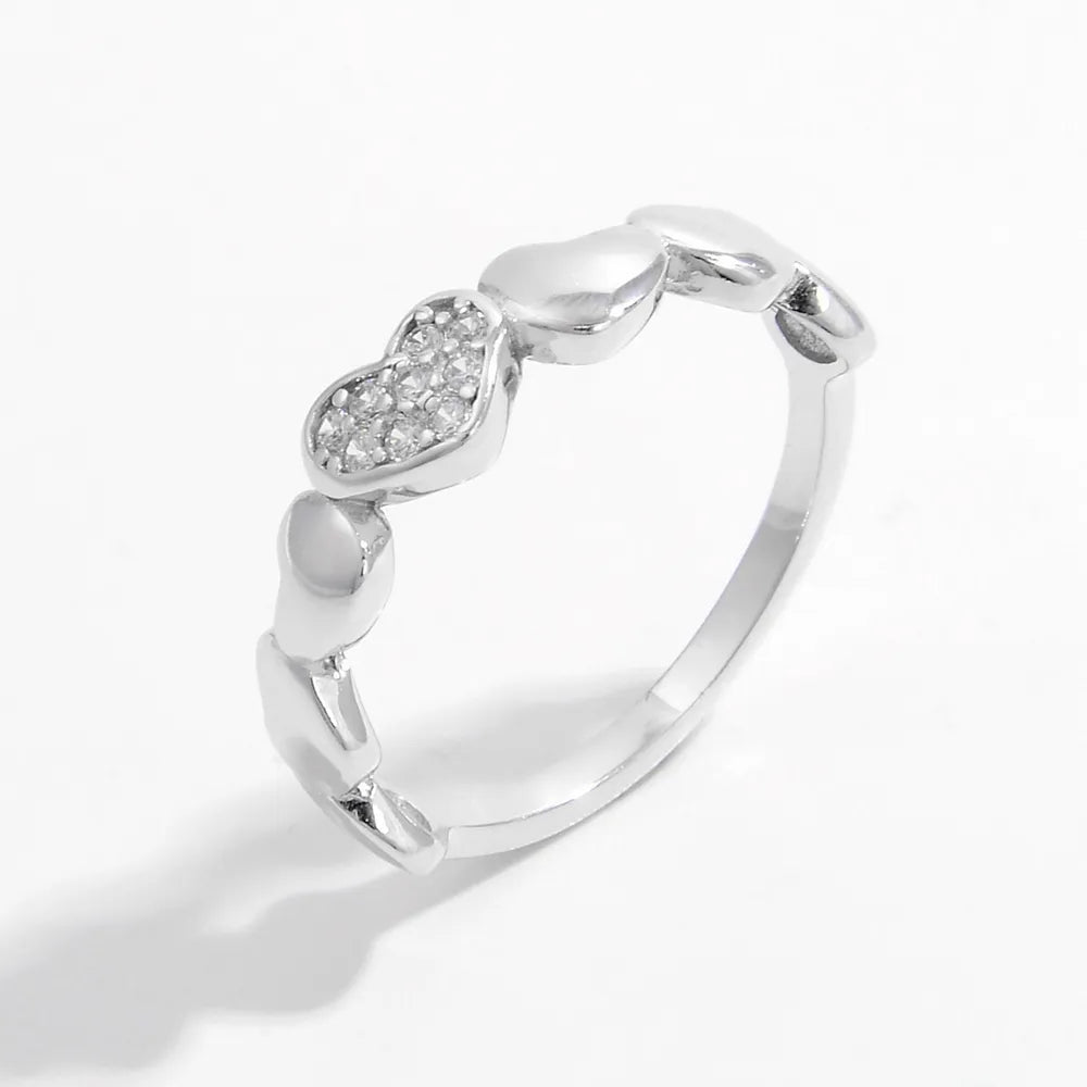 925 Sterling Silver heart ring with inlaid zircon stones, featuring a detailed design and polished finish, ideal for elegant jewelry accessories.