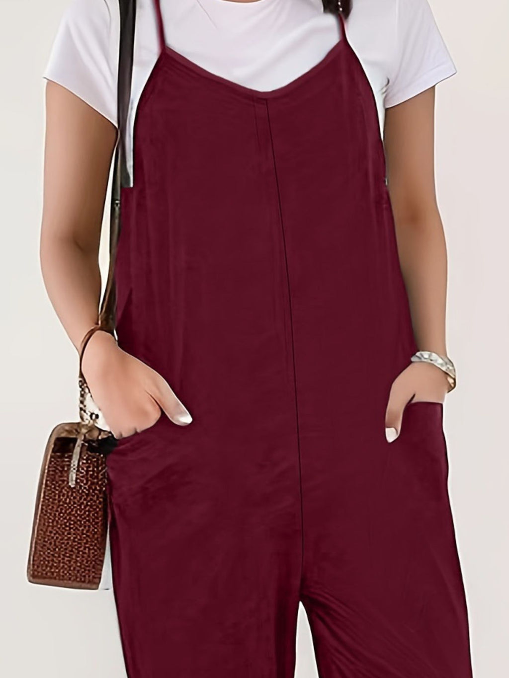 Casual loose fit spaghetti strap jumpsuit with pockets by Trendsi, featuring a relaxed style and lightweight fabric.