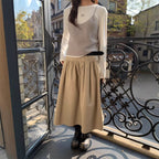 FitiqueFit relaxed A-line cotton midi skirt with crushed pleats and belt, casualwear style, shown with a flowy silhouette and neutral color.